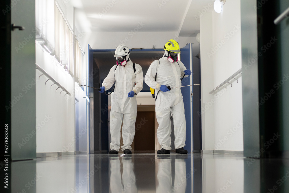 Firefighters disinfecting the interior of a building Firefighters disinfecting the interior of a building