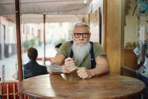 Hipster dandy man sitting in cafe photo