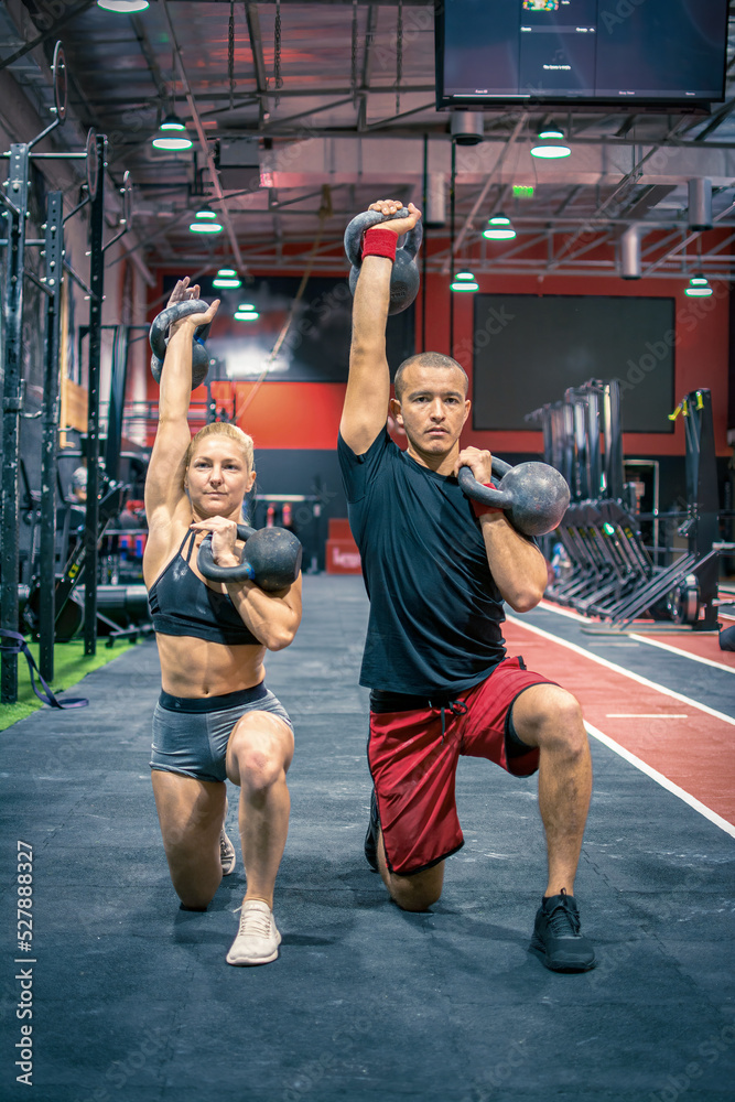 Horizontal view of sporty couple exercising together in lunges position
