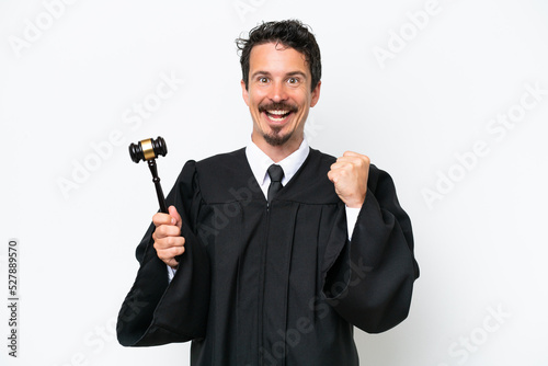Young judge caucasian man isolated on white background celebrating a victory in winner position