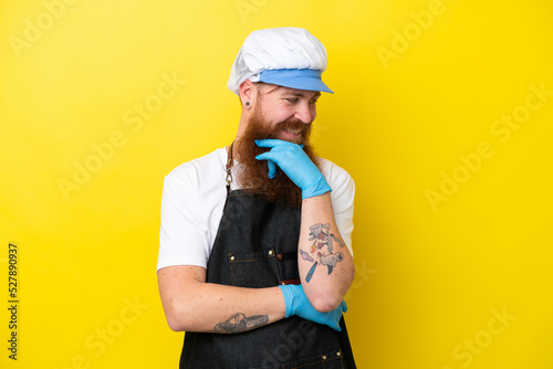 Fishmonger wearing an apron isolated on yellow background looking to the side