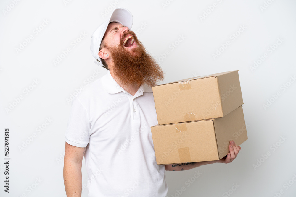 Delivery reddish man isolated on white background laughing Delivery reddish man isolated on white background laughing