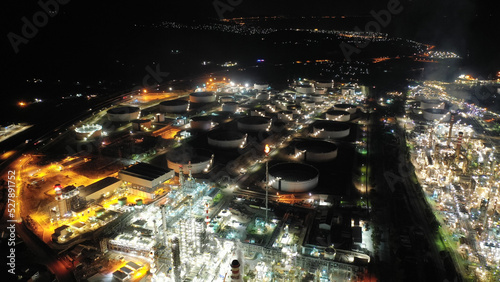 Aerial drone night shot of illuminated industrial crude oil refinery near area of Isthmus canal, Corinth, Greece