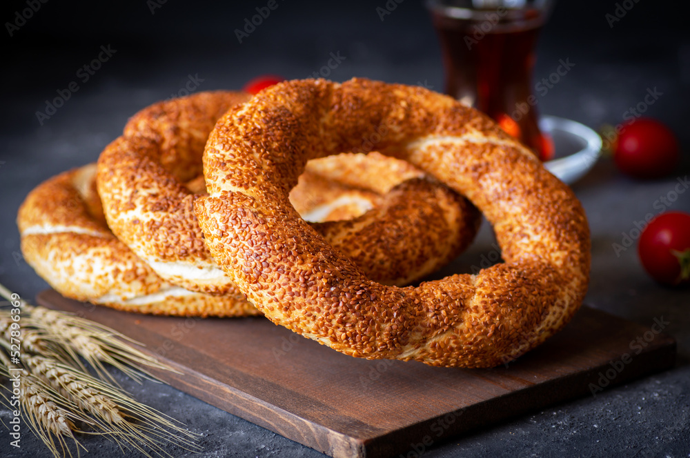 Turkish traditional bagel / simit with sesame on rustic table, turkish breakfast pastry concept - obrazy, fototapety, plakaty 