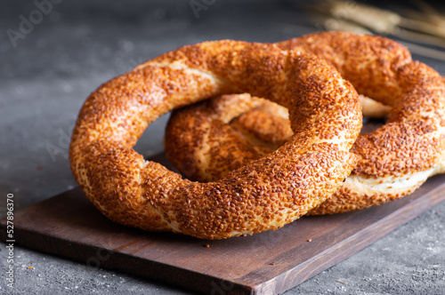 Turkish traditional bagel / simit with sesame on rustic table, turkish breakfast pastry concept