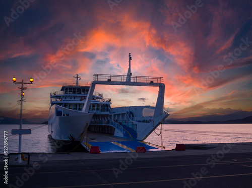 Port with ferryboat at sunset in spa resort Loutra Edipsou on island Evia in Greece photo