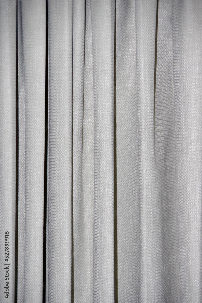 Close-up view of a light gray heavy curtain fabric Close-up view of a light gray heavy curtain fabric