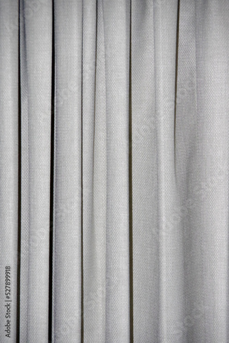 Close-up view of a light gray heavy curtain fabric