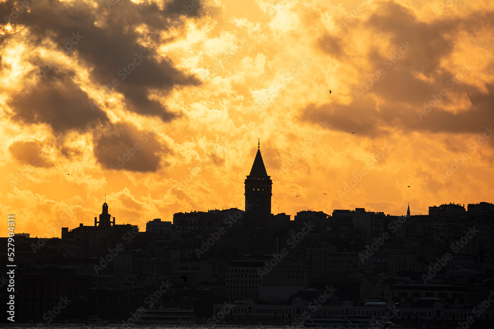 Galata Tower on a cloudy day. Galata Tower after sunset in Istanbul Turkey.