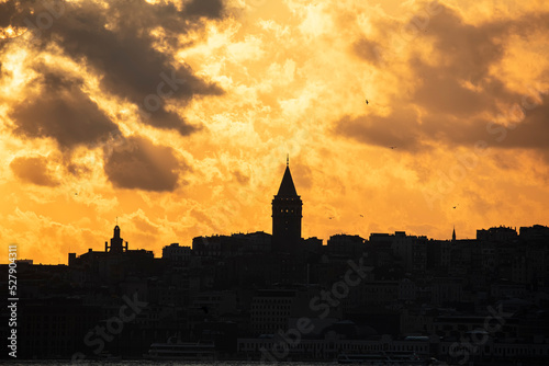 Galata Tower on a cloudy day. Galata Tower after sunset in Istanbul Turkey.