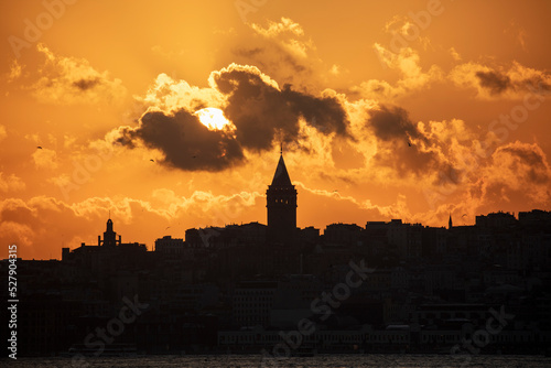 Galata Tower on a cloudy day. Galata Tower after sunset in Istanbul Turkey.