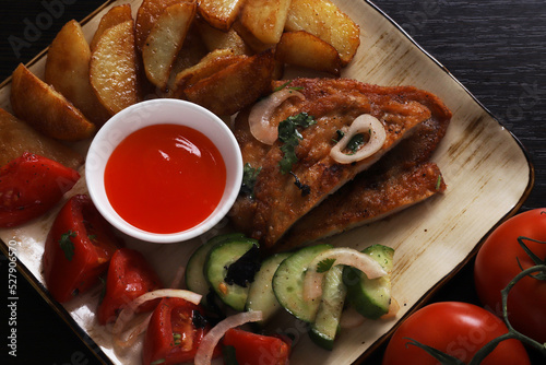 Langet, chop with vegetables on the sides. Shallow depth of field photo