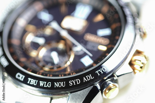 close up shallow focus Time zone cities code on luxury world time watch bezel on SYD Sydney, ADL Adelaide, NEU Neumea, TYO Tokyo. photo