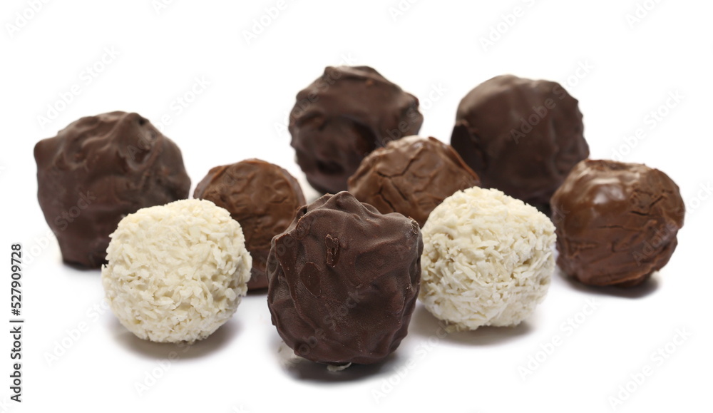 Round dark chocolates cream, milky hazelnut and white cream chocolates isolated on white Round dark chocolates cream, milky hazelnut and white cream chocolates isolated on white