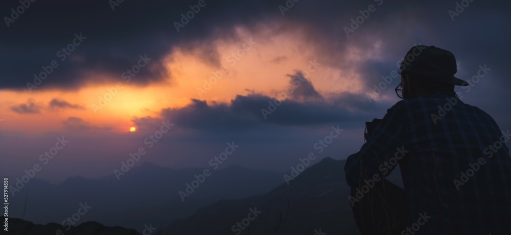 silhouette of a person in the mountains