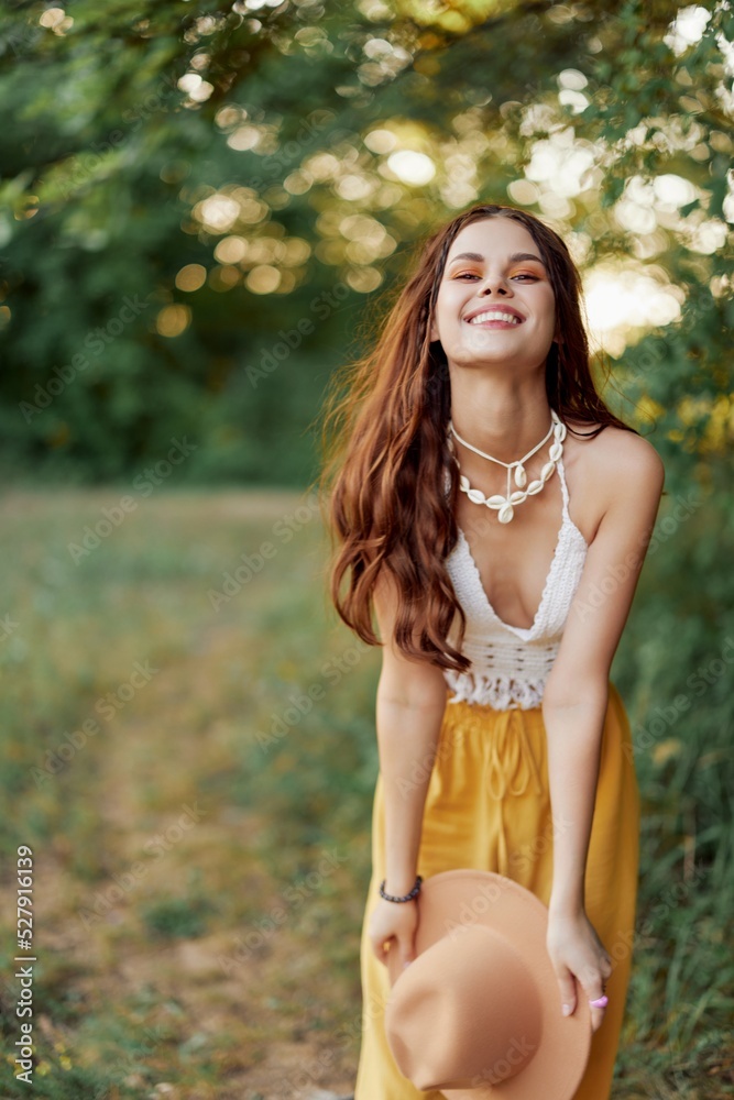 A young hippie woman dancing merrily and smiling earnestly in nature in the fall. The concept of economical consumption and self-care A young hippie woman dancing merrily and smiling earnestly in nature in the fall. The concept of economical consumption and self-care