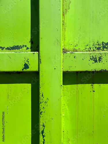 Closeup of a green garbage bin and abstract cross. Concept of environmentalism, religion and climate change denial.