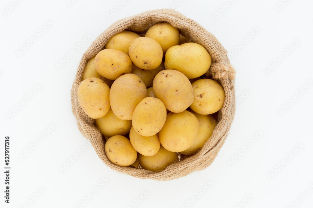 Sack of fresh raw potatoes on wooden background, top view Sack of fresh raw potatoes on wooden background, top view