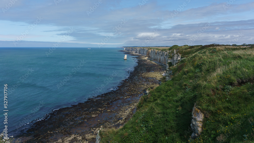 High angle view at teh coastline with chalk cliffs, rock formations and green hills on a summer day at Etretat, Normandy, France