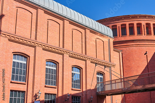 red brick buildings and a metal footbridge and a historic old brewery