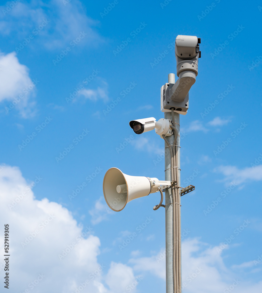 Modern CCTV cameras and alarm siren mounted on a pole Modern CCTV cameras and alarm siren mounted on a pole