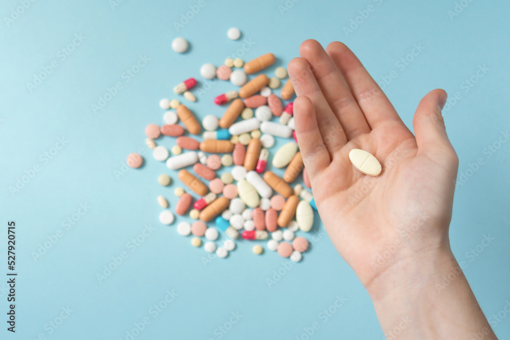 Palm with pill close up. Teenager's hand with medicines. The concept of drug selection, top view