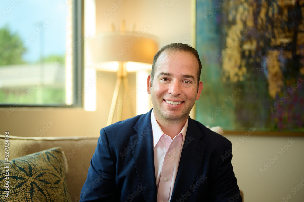 THE WOODLANDS, TEXAS - SEPTEMBER 1ST 2022: Doctor is posing in a suit for environmental portraits at his medical office The Woodlands Plastic Surgery to promote his business at Living Magazine THE WOODLANDS, TEXAS - SEPTEMBER 1ST 2022: Doctor is posing in a suit for environmental portraits at his medical office The Woodlands Plastic Surgery to promote his business at Living Magazine