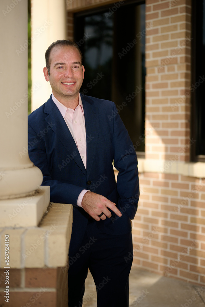 THE WOODLANDS, TEXAS - SEPTEMBER 1ST 2022: Doctor is posing in a suit for environmental portraits at his medical office The Woodlands Plastic Surgery to promote his business at Living Magazine THE WOODLANDS, TEXAS - SEPTEMBER 1ST 2022: Doctor is posing in a suit for environmental portraits at his medical office The Woodlands Plastic Surgery to promote his business at Living Magazine