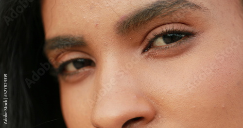 African woman opening eyes, macro closeup of young black girl eyes