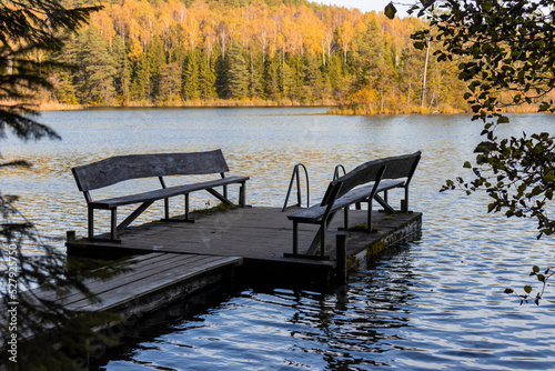 pier with benches on a forest lake in the autumn forest. Naroch Park Blue Lakes photo