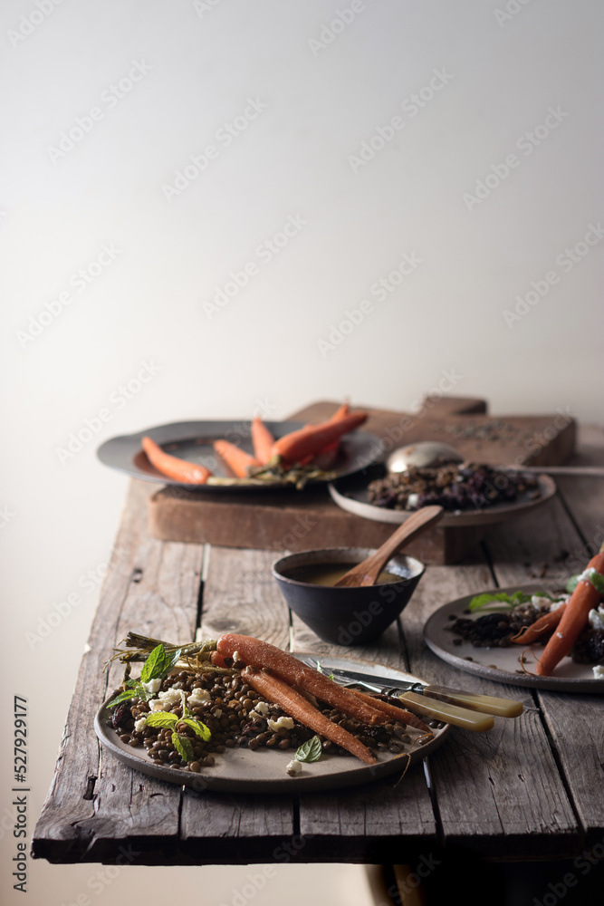 Served plates of organic salad on wooden table Served plates of organic salad on wooden table