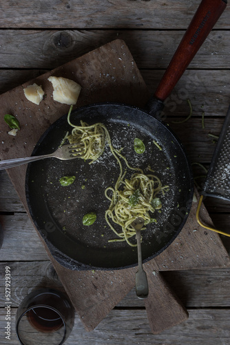 Tasty spaghetti with pesto sauce, spinach and parmesan cheese photo