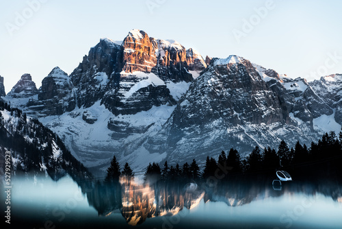 Reflection in a mirror of the Dolomites in Madonna di Campiglio during sunset, Northern Italy
