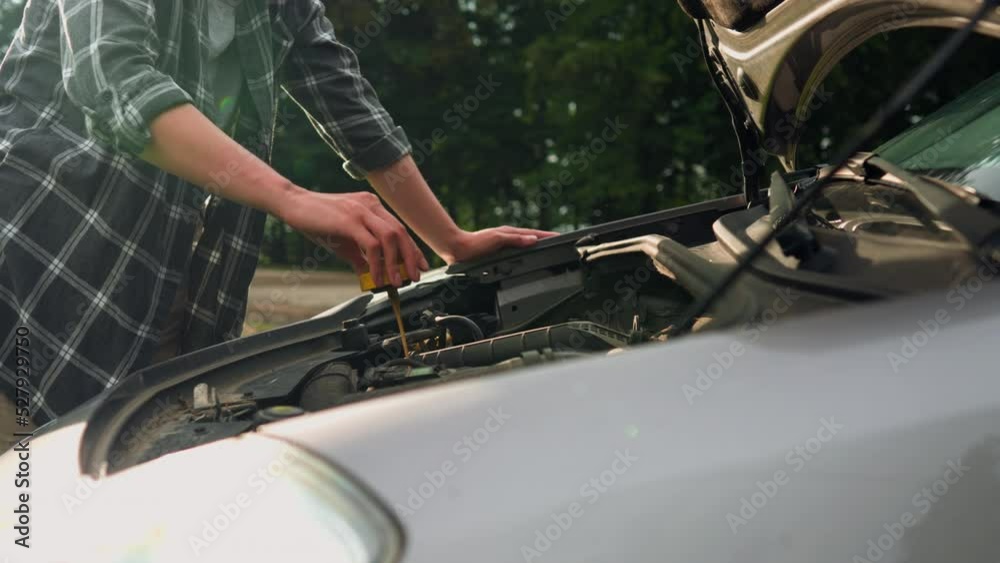 Breakdown of the car open the hood of the car girl driver checks the condition of the engine while standing on the track. Checking the engine oil level girl stands on the motorway
Breakdown of the car open the hood of the car girl driver checks the condition of the engine while standing on the track. Checking the engine oil level girl stands on the motorway