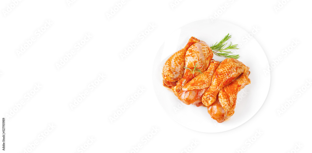 Baner.Cooking chicken drumsticks.Raw chicken legs in a marinade with rosemary on a background.Top view, copy space.Isolated.Marinated chicken dramstick with spices for cooking. Baner.Cooking chicken drumsticks.Raw chicken legs in a marinade with rosemary on a background.Top view, copy space.Isolated.Marinated chicken dramstick with spices for cooking.