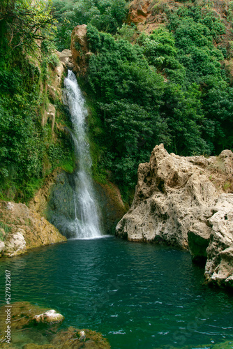 waterfall over a natural pool for bathing in crystalline waters.