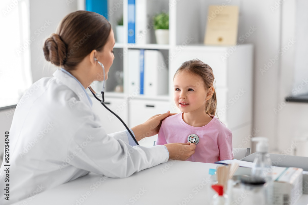 medicine, healthcare and pediatry concept - female doctor or pediatrician with stethoscope and little girl patient on medical exam at clinic medicine, healthcare and pediatry concept - female doctor or pediatrician with stethoscope and little girl patient on medical exam at clinic
