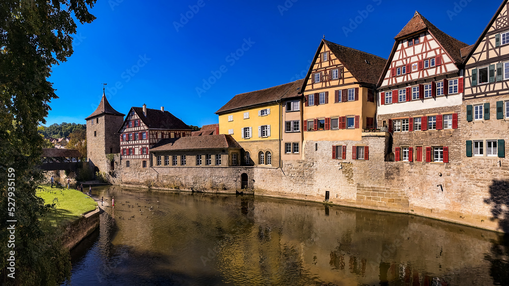Idyllic panorama in a German old town on a river with city wall and half-timbered houses
