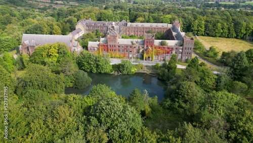 Aerial descending shot of abandoned college building photo