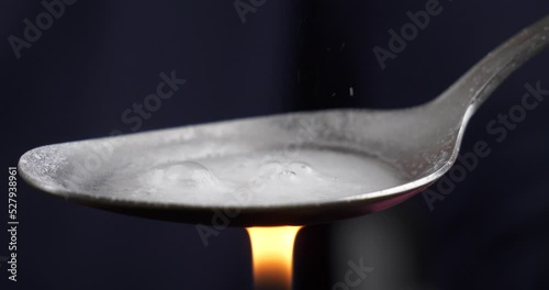 cooking with a lighter a narcotic substance on a spoon, boiling crystal drugs High quality 4k footage