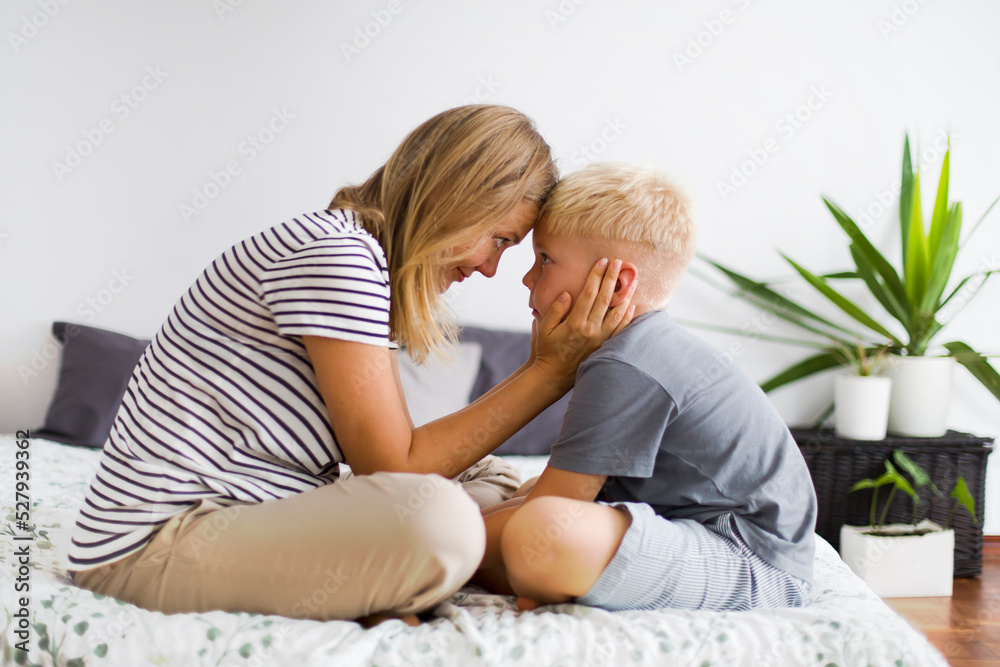lovely emotional scene with happy mother and son in bedroom lovely emotional scene with happy mother and son in bedroom