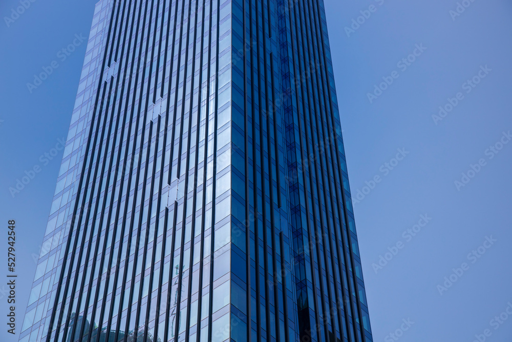 Detail of skyrise building with blue sky Detail of skyrise building with blue sky