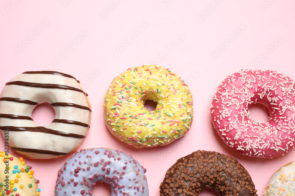 Delicious glazed donuts on pink background, flat lay Delicious glazed donuts on pink background, flat lay