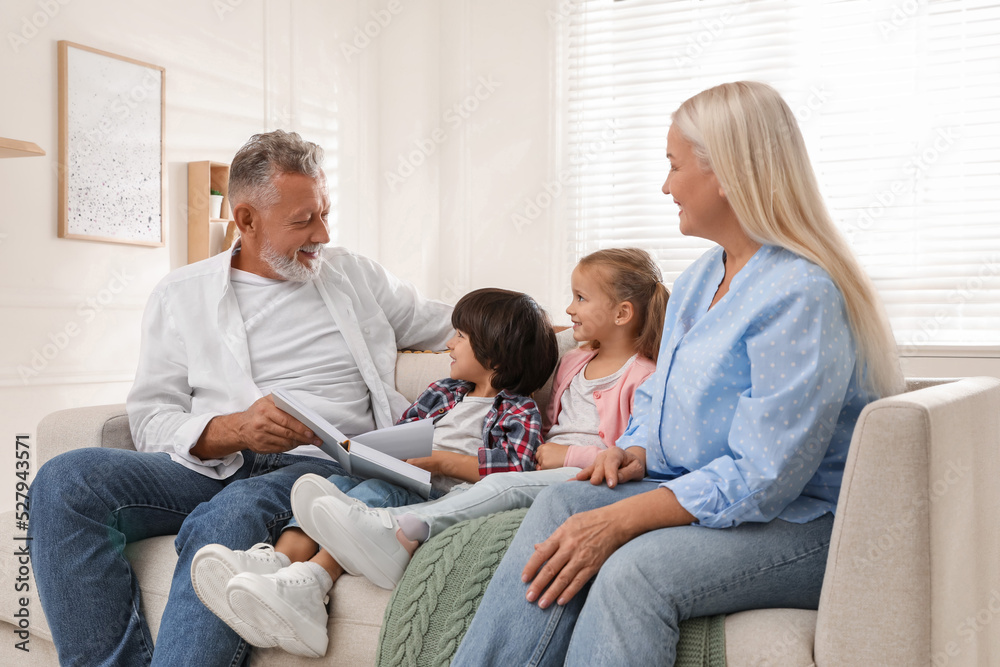 Happy grandparents spending time with grandchildren at home Happy grandparents spending time with grandchildren at home