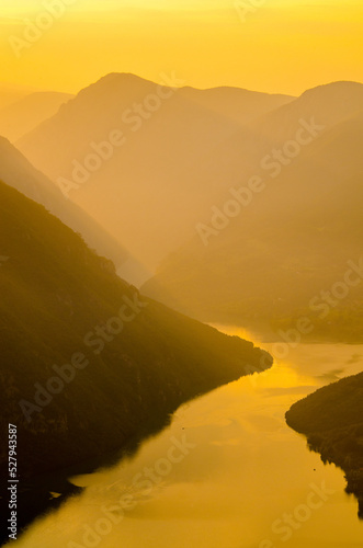 Beautiful landscape showing mountains, valley and river on a sunny summer day 