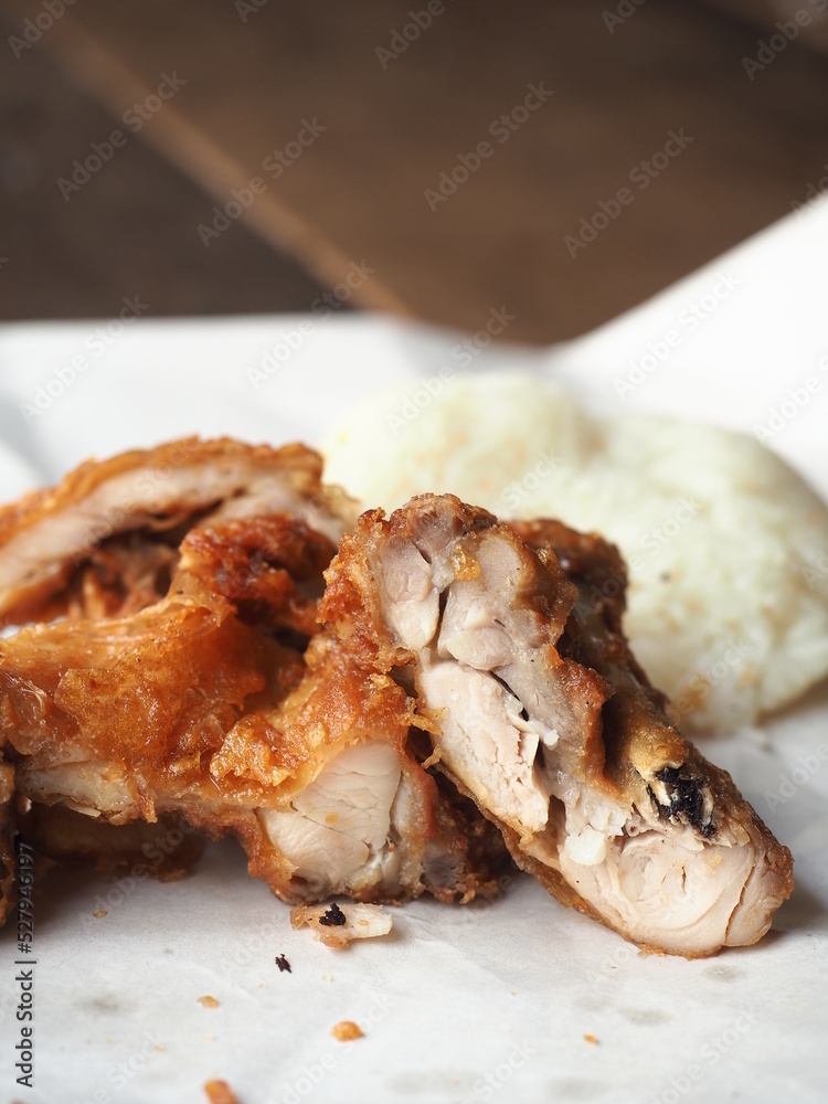 sliced crispy fried chicken with sticky rice on paper sliced crispy fried chicken with sticky rice on paper