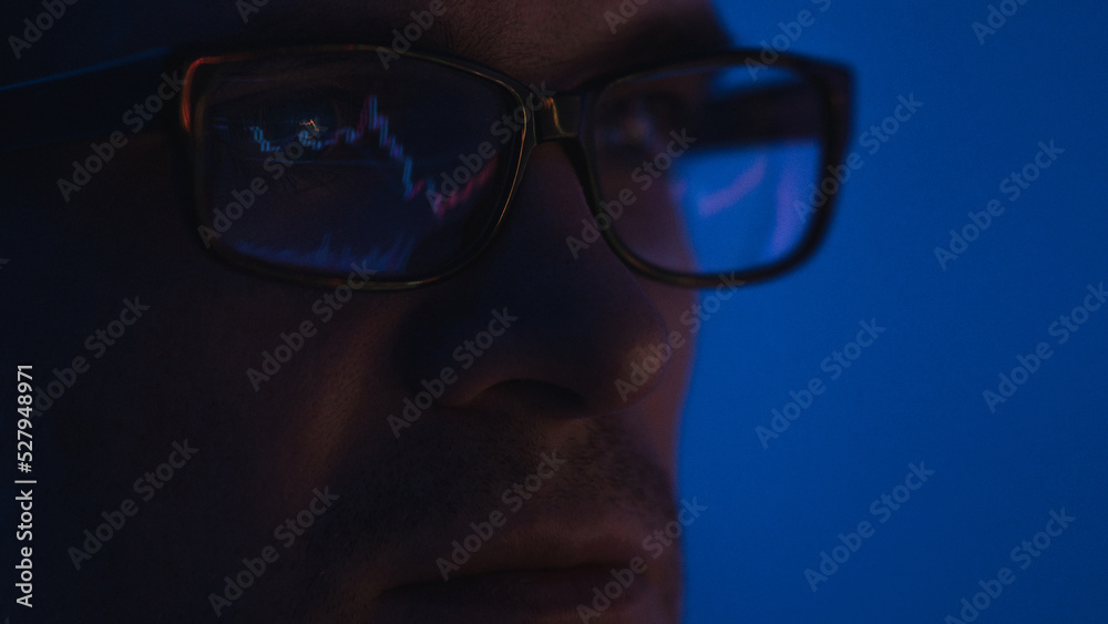 pulse of the market, a male trader with glasses sits in front of the monitor and looks at the chart of the market price of stocks or currencies, the securities market or the crypto exchange pulse of the market, a male trader with glasses sits in front of the monitor and looks at the chart of the market price of stocks or currencies, the securities market or the crypto exchange