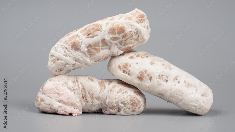 frozen homemade meat raw cutlet closeup on gray background frozen homemade meat raw cutlet closeup on gray background