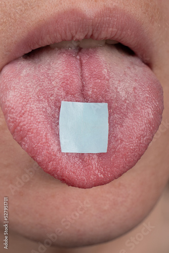 hippie use lsd mark ,lysergic acid in tongue closeup photo
