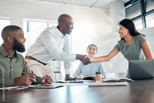 Handshake, office diversity and meeting welcome for company onboarding or partnership together. Introduction, agreement and negotiation with workforce people in corporate company boardroom.